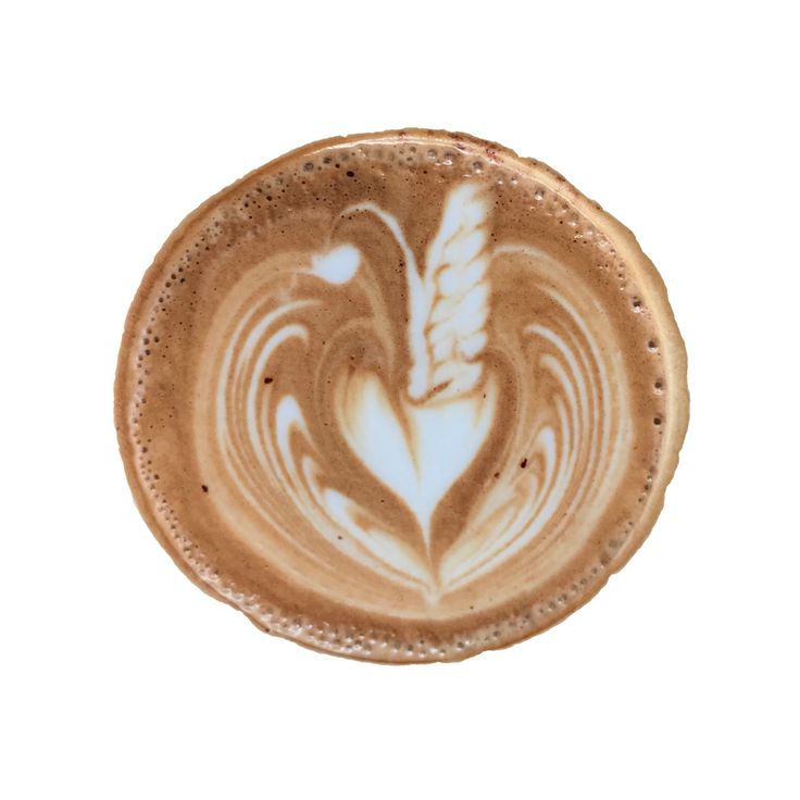 a cappuccino with white swirls in the shape of a heart on a white background