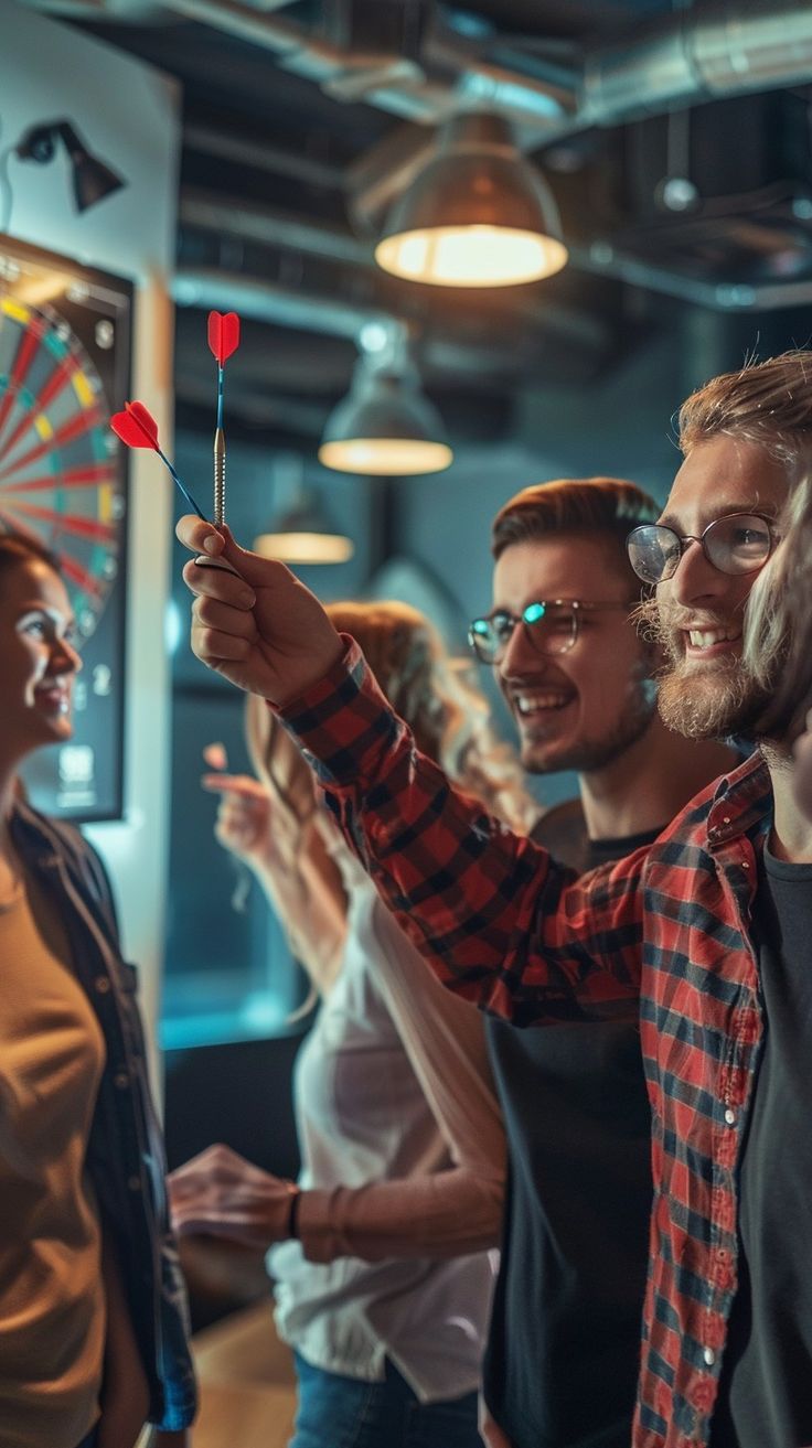 two men and one woman are taking pictures with their cell phones