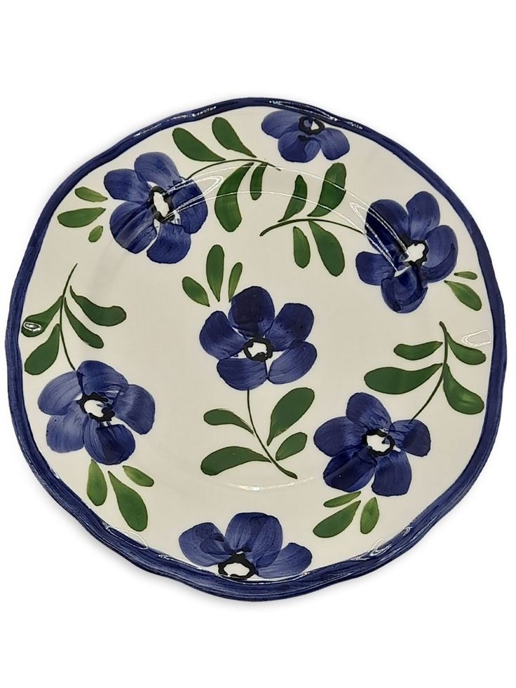 a blue and white plate with flowers on it