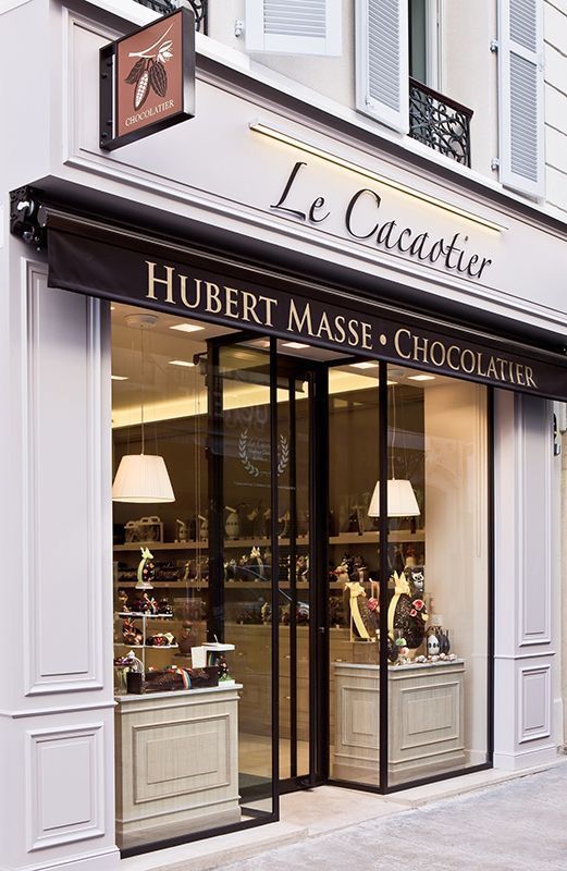 a store front with two lamps on the outside and one lamp in the window that says, le cauveur