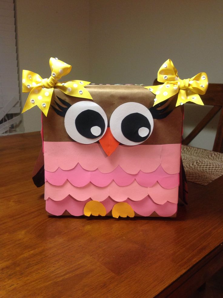 an owl shaped bag sitting on top of a wooden table