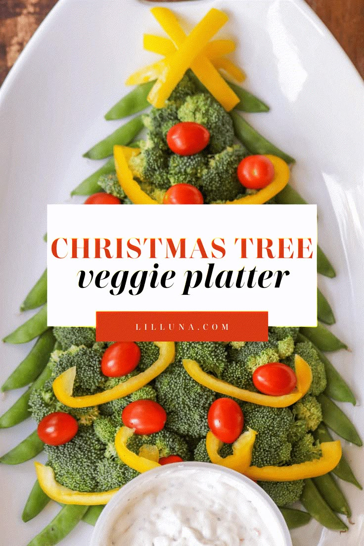 a christmas tree veggie platter with ranch dip and vegetables on the side