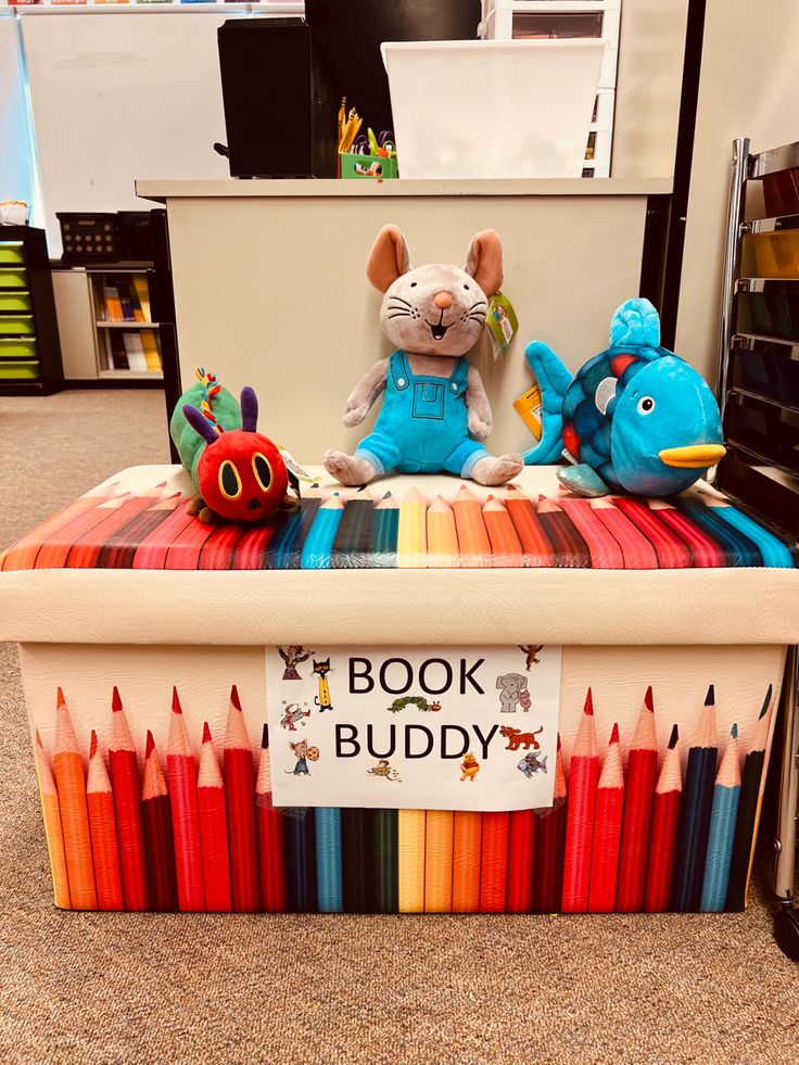 a toy box filled with lots of colored pencils and stuffed animals on top of it