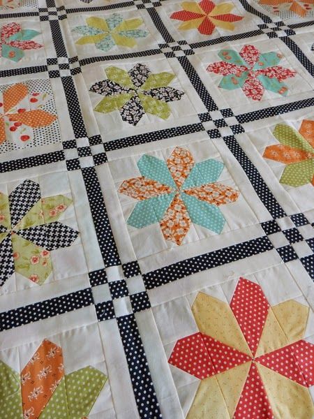 a quilted table topper with flowers on it