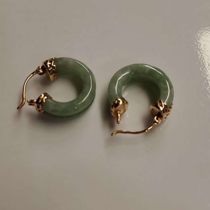 14k Yellow Gold Jade Hoop Earrings. These Are Set With A Carved Hoop Jade. Weigh A Total Of 5.6 Grams. 17mm In Diameter And 6 Mm Width Jade Hoop Earrings, Green 14k Gold Hoop Earrings, Elegant Green Small Hoop Huggie Earrings, Gold Jade Hoop Jewelry, Elegant Green Hoop Huggie Earrings, Elegant Jade Hoop Earrings, Gemstone Hoop Earrings Fine Jewelry, Green Round Huggie Earrings For Pierced Ears, Green Round Huggie Earrings