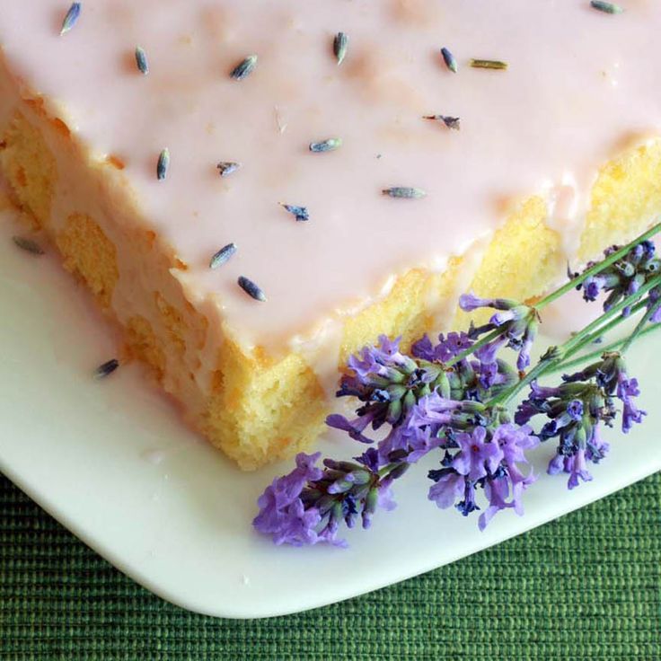 a piece of cake sitting on top of a white plate with lavender sprinkles