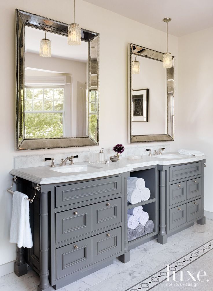 a bathroom with two sinks and mirrors in it