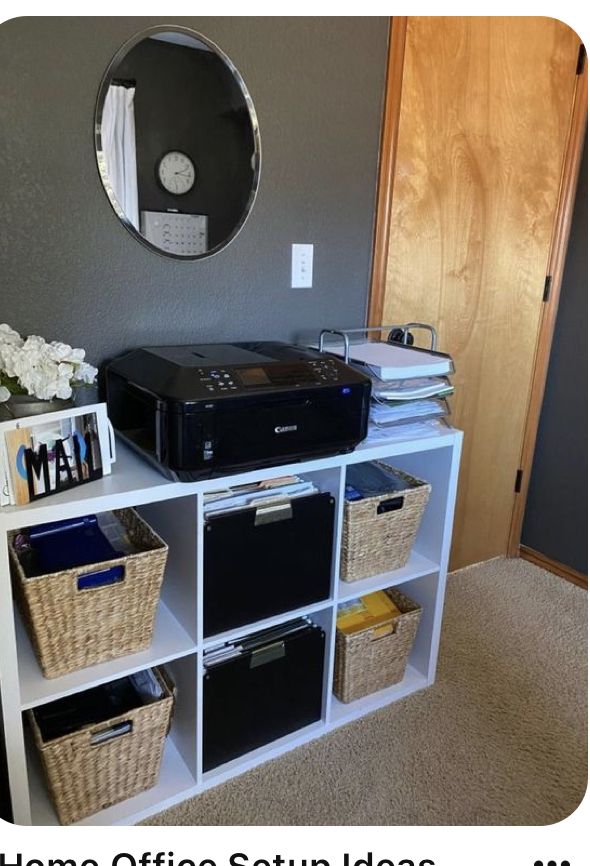 a white shelf with some baskets on top of it and a mirror above the shelves