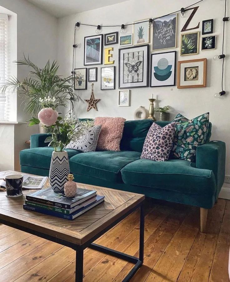 a living room with blue couches and pictures on the wall above it's coffee table