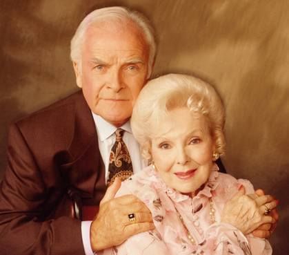 an older couple posing for a christmas card