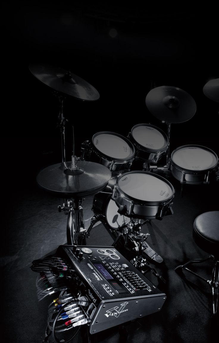 a man sitting in front of a drum set