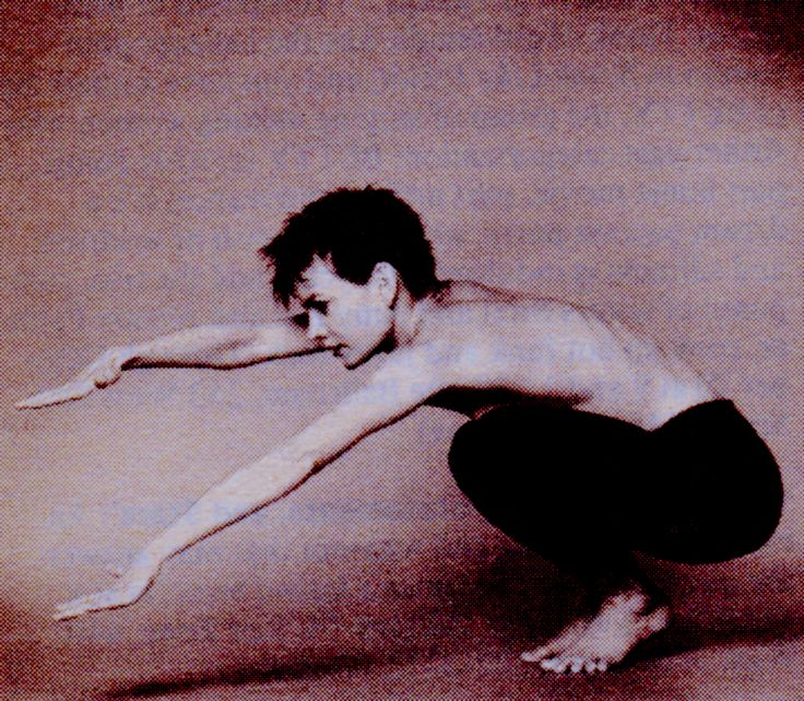 a shirtless man stretching his arms and legs