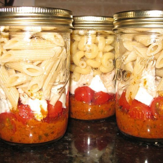 three mason jars filled with pasta and sauce