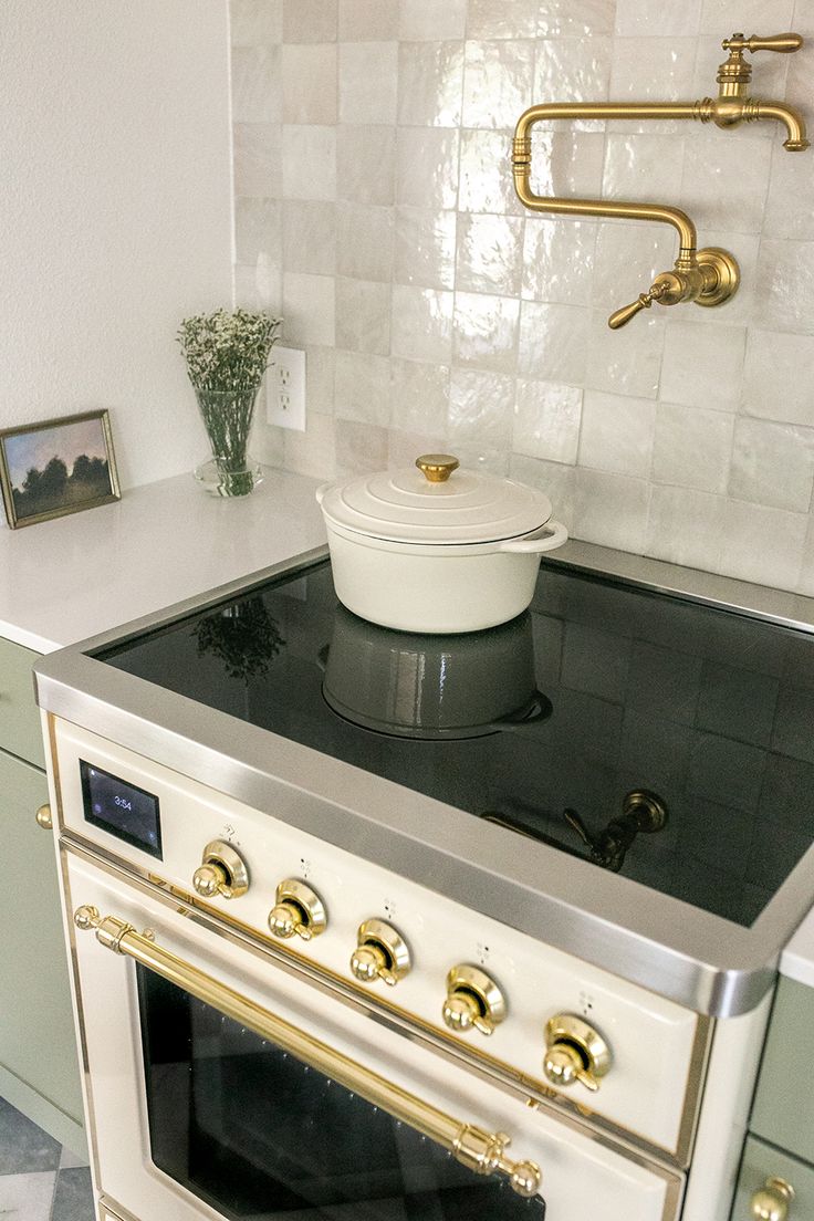 a white stove top oven sitting inside of a kitchen next to a wall mounted oven