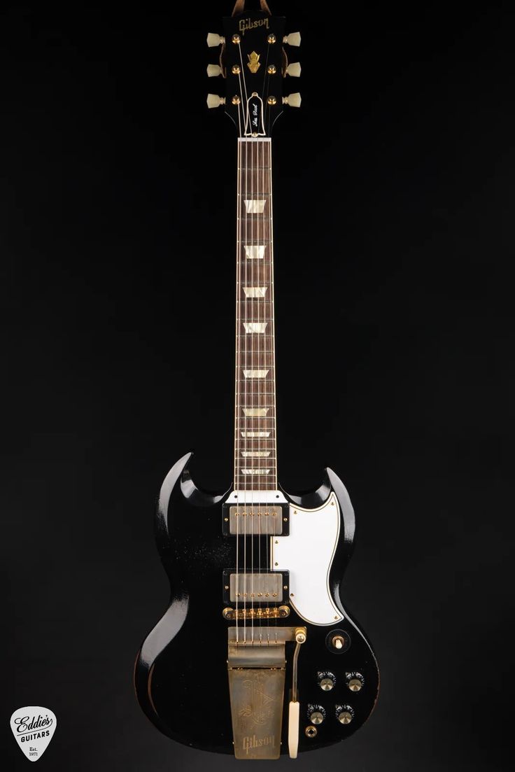 an electric guitar is shown against a black background