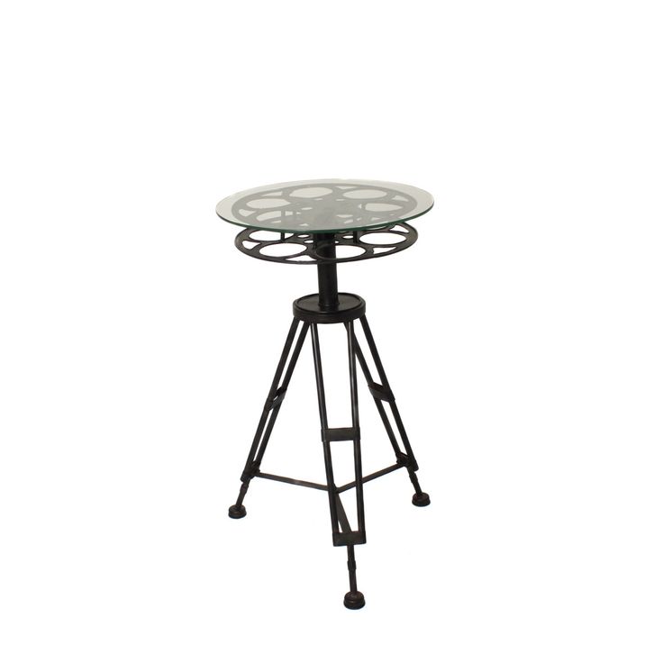 a glass table sitting on top of a metal stand with wheels around the base and legs