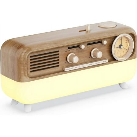 an old fashioned radio sitting on top of a wooden stand with a clock in the center