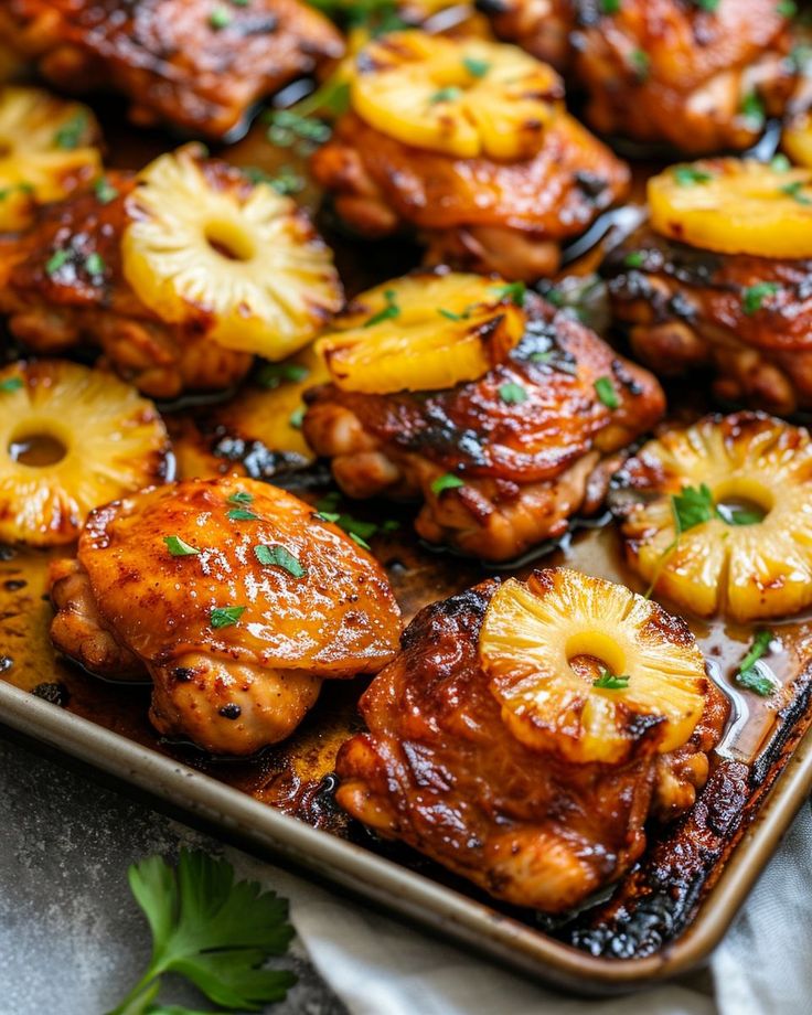 chicken and pineapples on a baking sheet with parsley in the middle, ready to be eaten