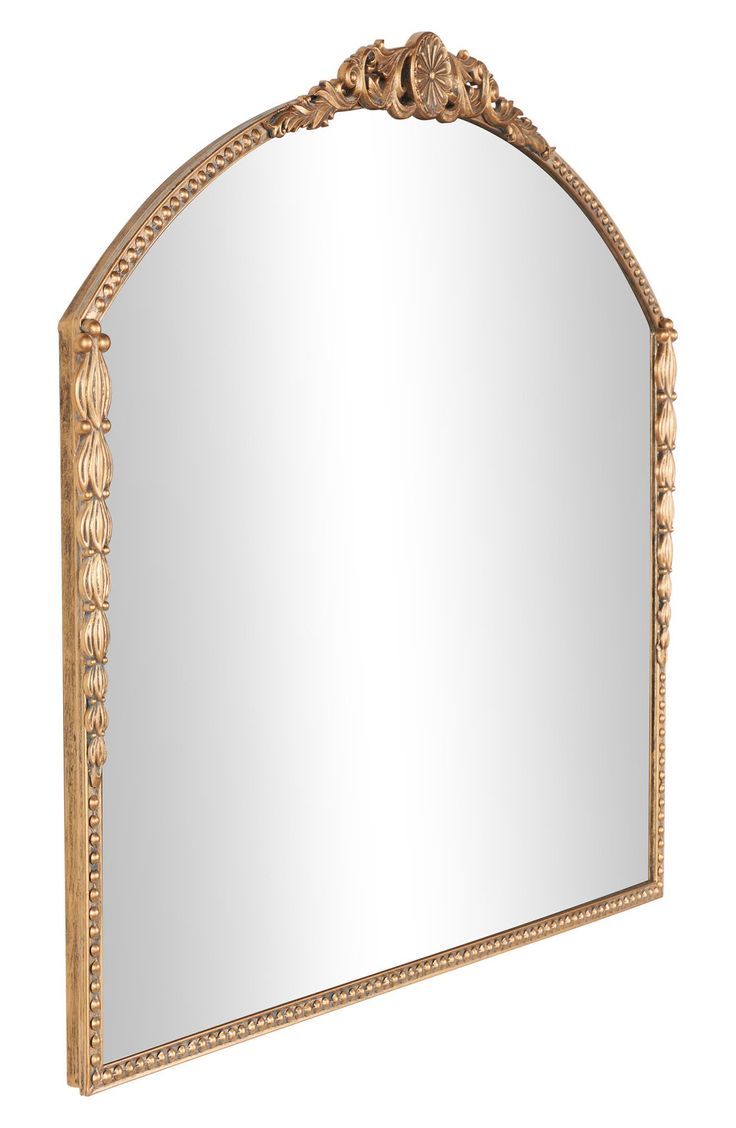 an ornate gold framed mirror on a white background