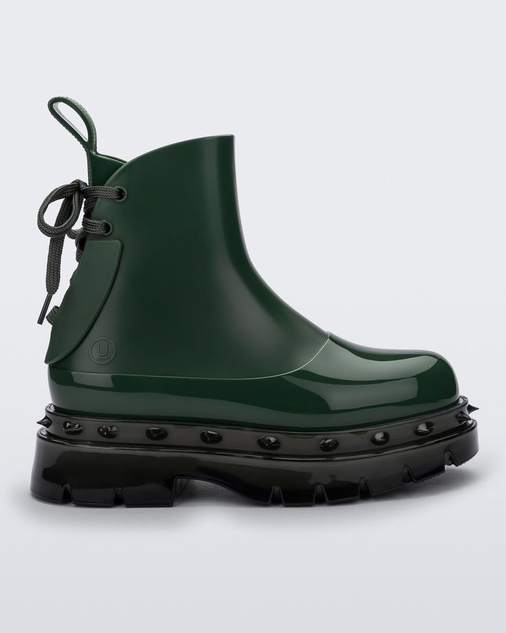 Side view of a green Melissa Spikes Boot with spike details around the sole and laces in the back. Green Tigh High Boots, Shiny Rubber Boots, Jade Green Boots, Green Sole Boots, Green Vinyl Boots, Green Slouchy Boots, Jellypop Ankle Boots, Fatface Boots, Tuffa Boots