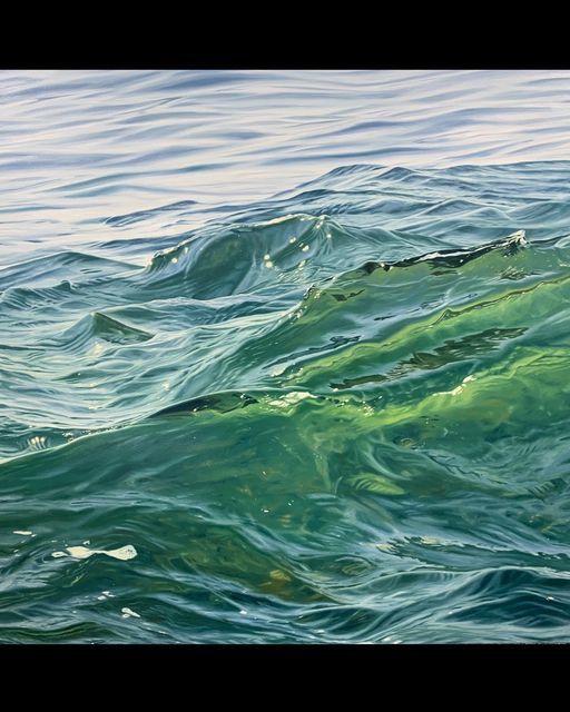 the water is green and blue with small waves