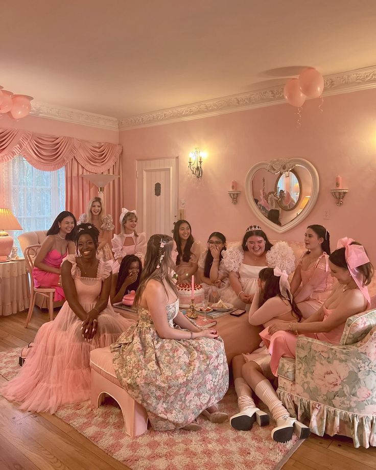 a group of women sitting around each other in front of a mirror on the wall