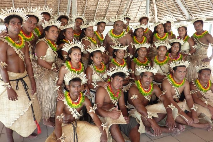 a group of men and women dressed in native garb