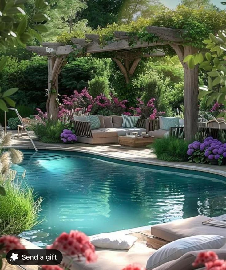 an outdoor pool surrounded by flowers and greenery