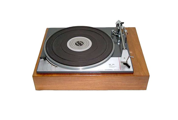 a turntable that is sitting on top of a wooden stand with a white background