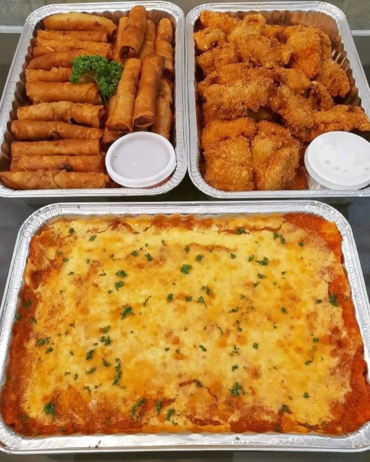 three trays filled with different types of food