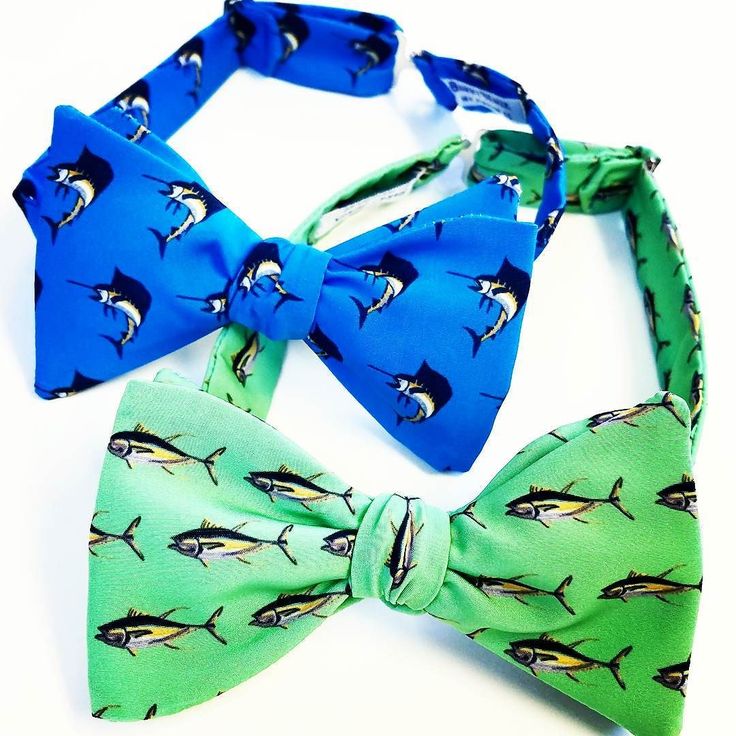 two bow ties with blue and green designs on them, one has a fish design