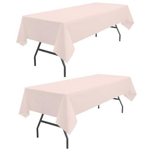 two tables with white tablecloths and black metal legs on each side, set against a white background