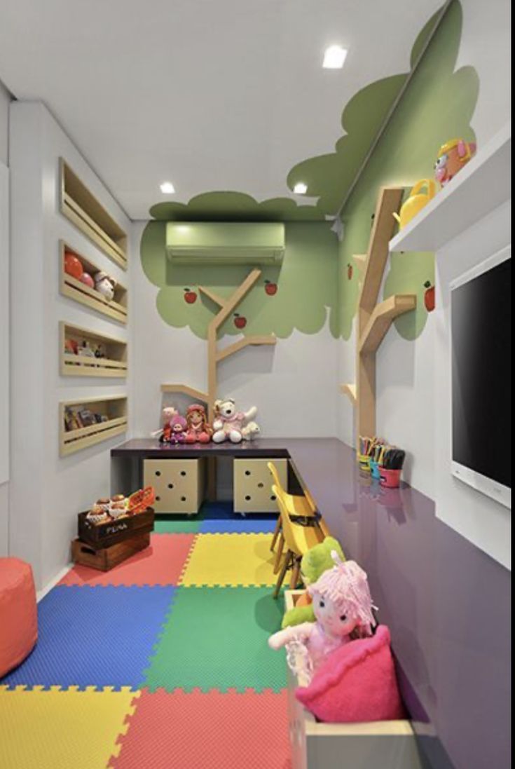 a child's playroom with colorful flooring and toys on the shelves, including stuffed animals