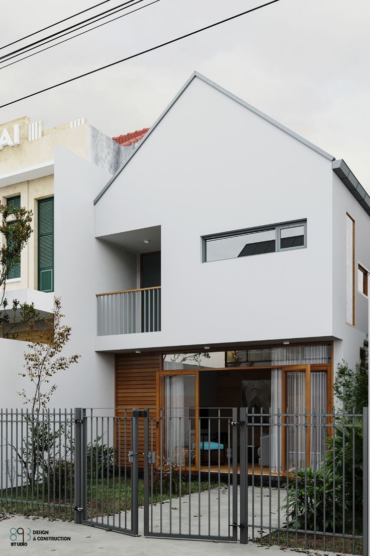 the house is white and has two balconies