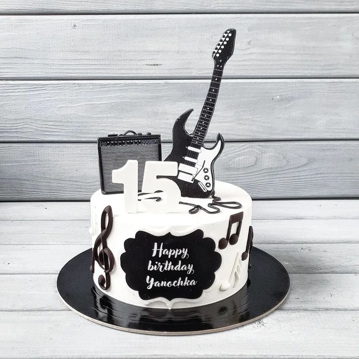 a black and white birthday cake with an electric guitar