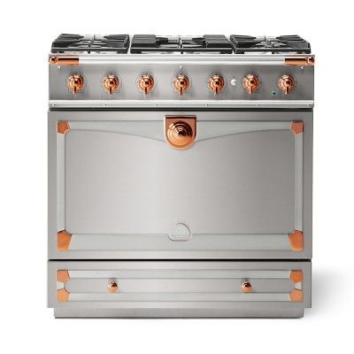 a silver and copper stove top oven with two burners on the front, and four burners on the back