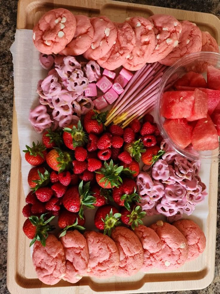 a tray filled with different types of food on top of a table next to strawberries