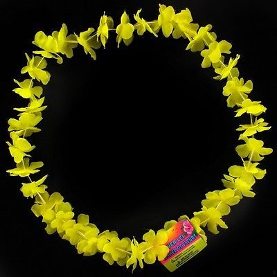 a yellow necklace with flowers on it and a candy bar in the middle, against a black background