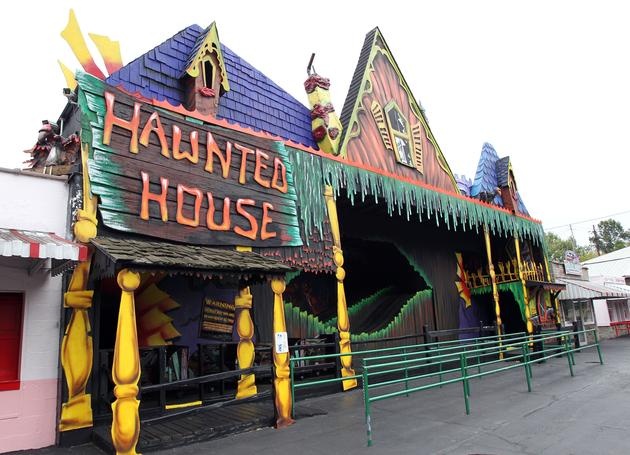 the halloween house is painted in bright colors and has decorations on it's roof