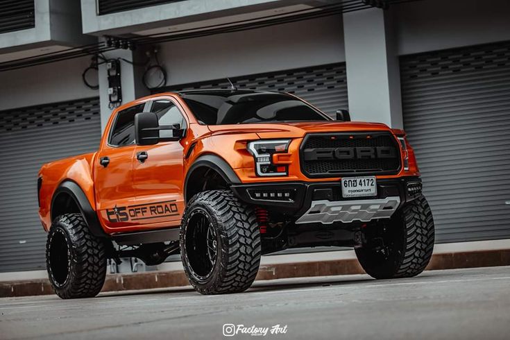 an orange truck parked in front of a building