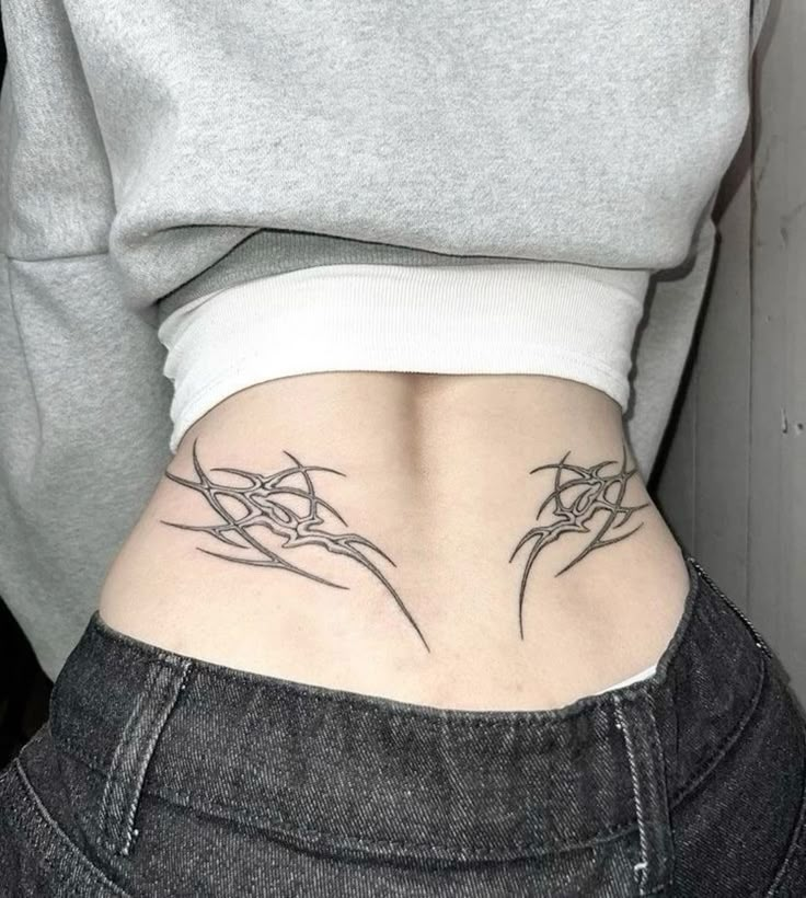 a woman's stomach with tattoos on it