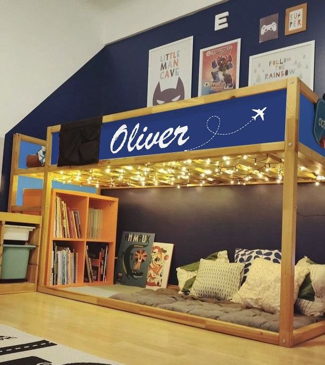 a bunk bed with a lit up name on the top and bottom shelf above it