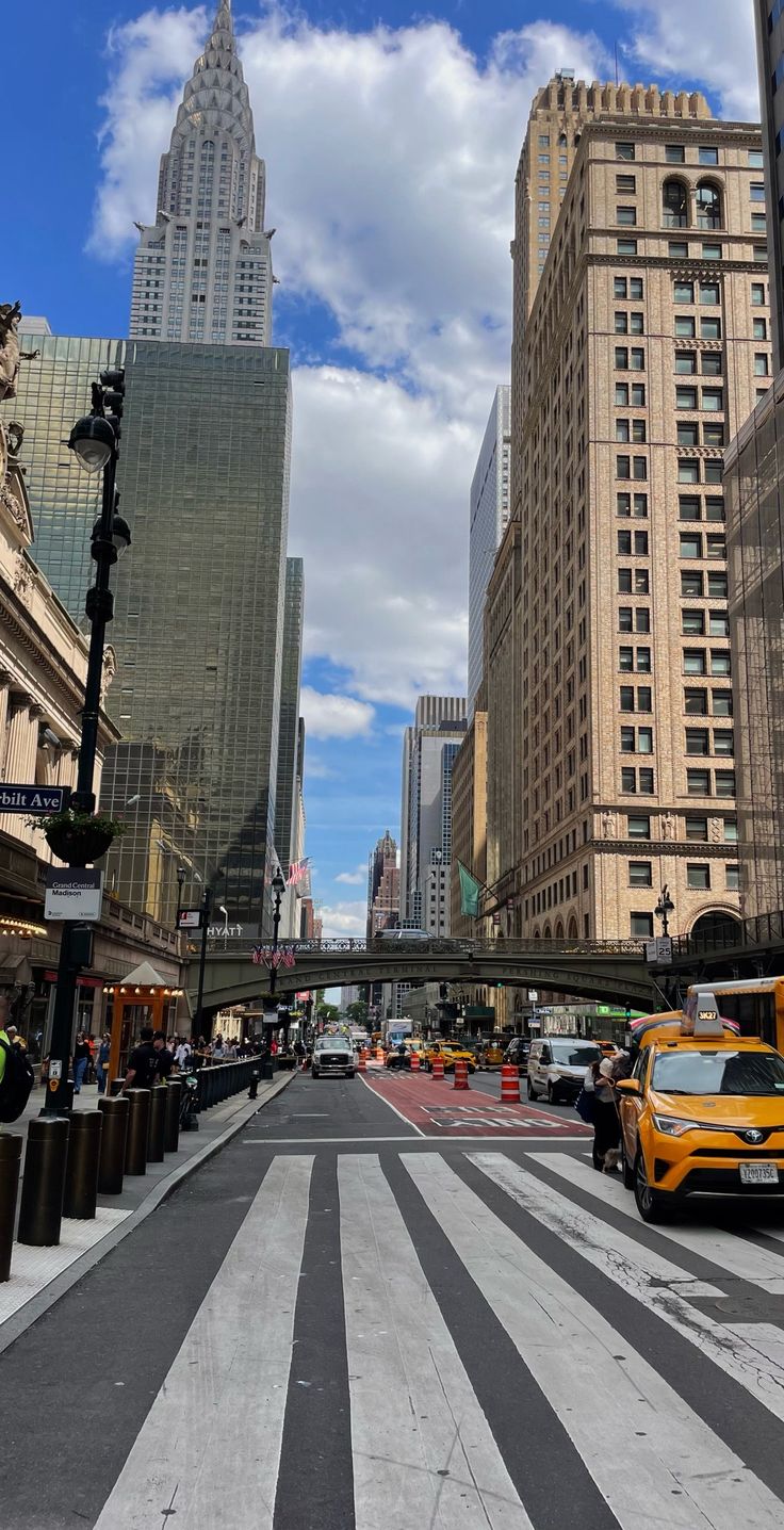 an empty city street with tall buildings in the background