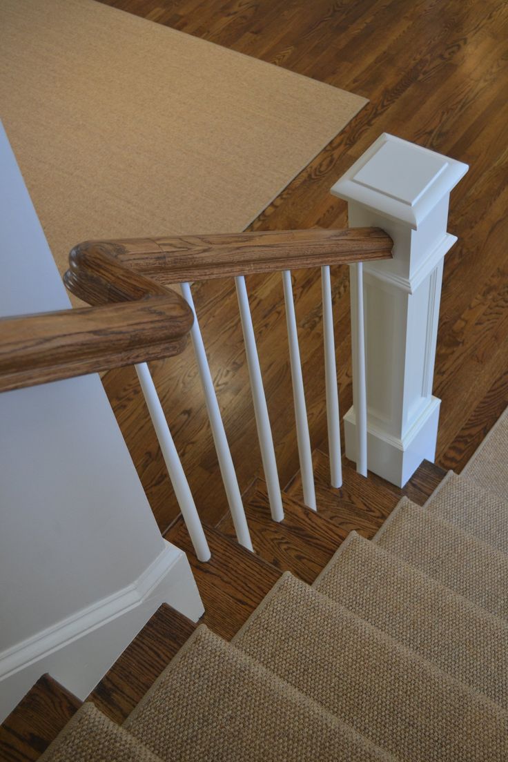 an overhead view of a staircase with white handrails and wood flooring on the ground