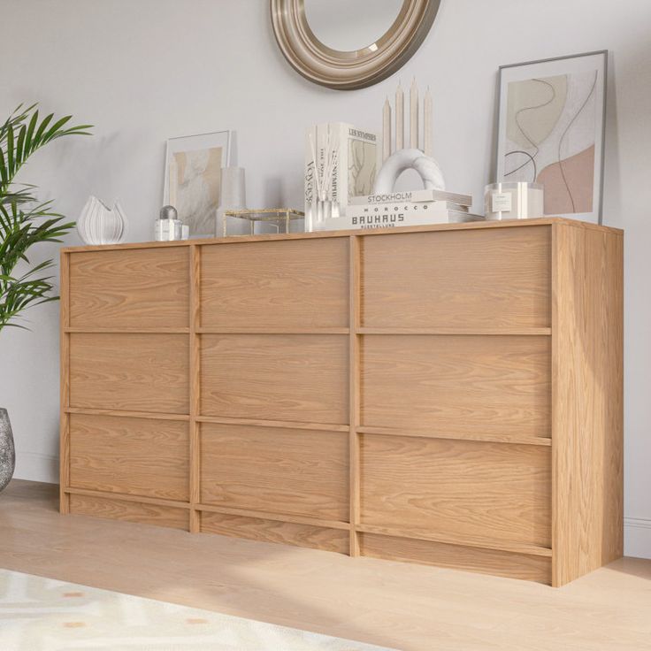 a large wooden dresser sitting next to a potted plant