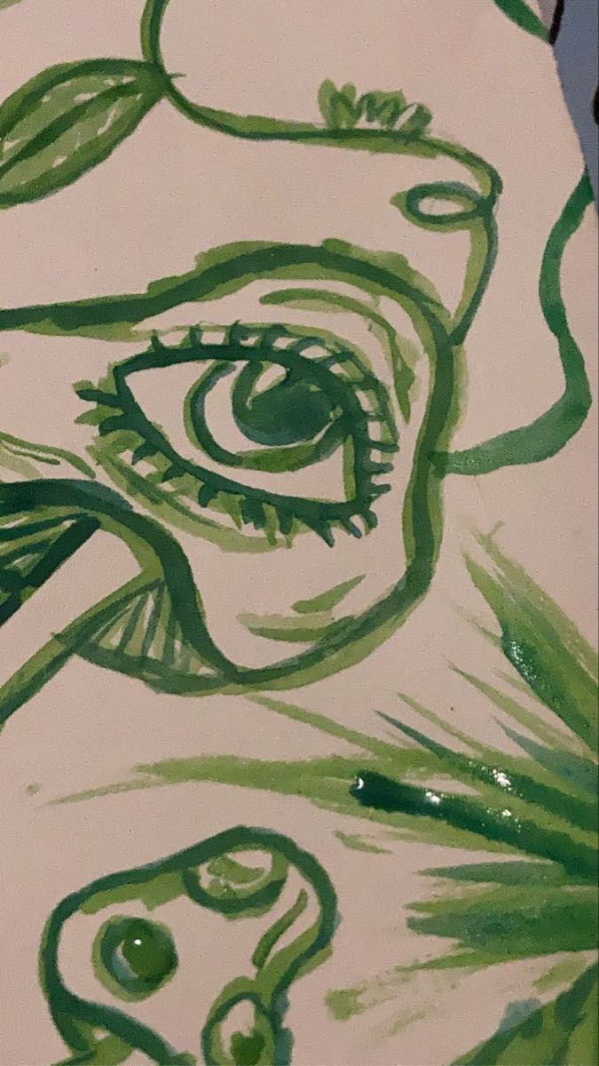 a painting with green and white paint on it that looks like a woman's face