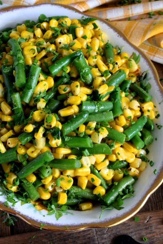 a white bowl filled with corn and green beans