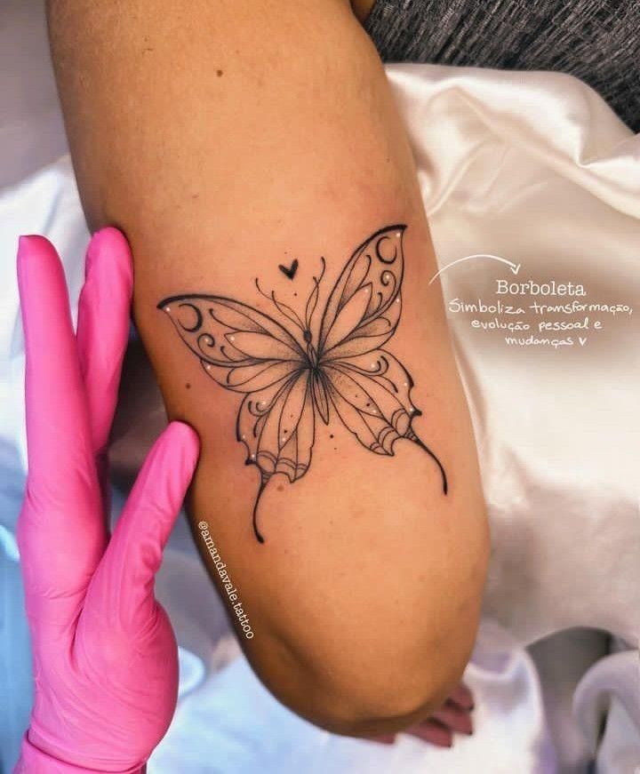 a woman's arm with a butterfly tattoo on it