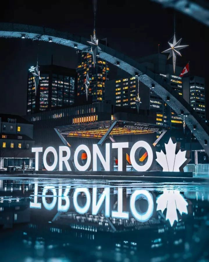 the toronto sign is lit up at night