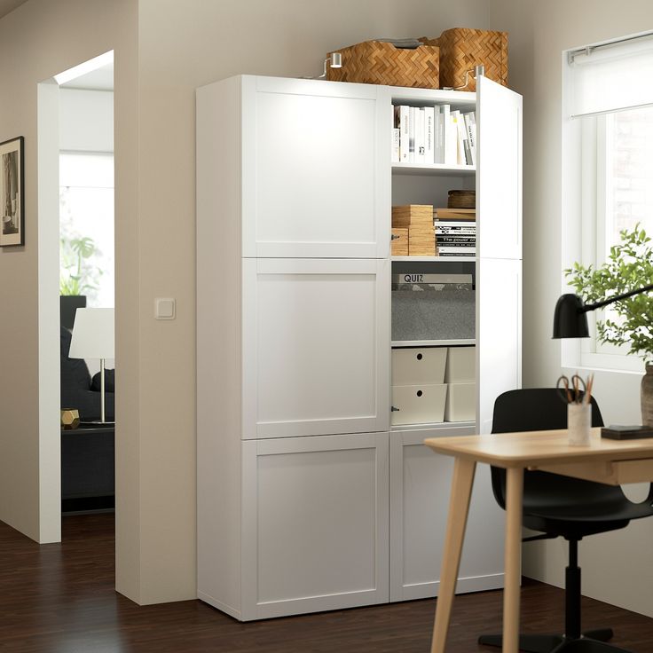 a room with a desk, chair and bookcase in it's center area